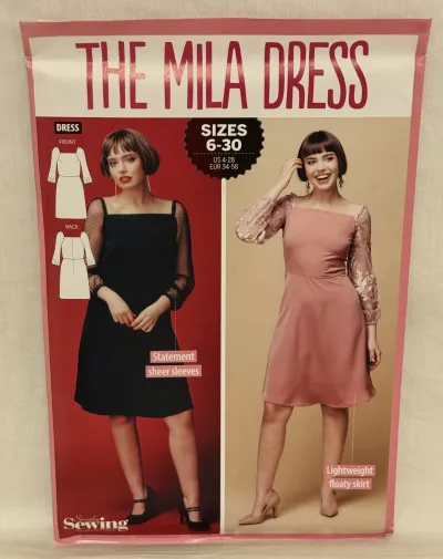 A sewing pattern for the Mila dress by Simply Sewing in sizes 6-30. On the cover are two women, one is wearing a black dress with tulle sleeves and the other is wearing a pink dress with tulle sleeves.
